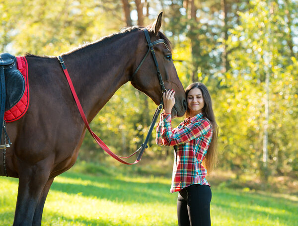 beautiful long hair young woman with a horse outdoor