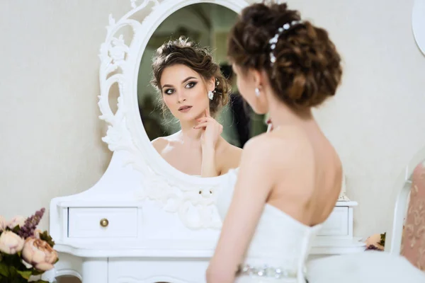 Beautiful young bride in front of the mirror. Portrait with wedd — Stock Photo, Image