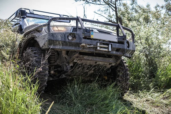 Photo of heavy off-road racing car overcomes hard pit. — Stock Photo, Image