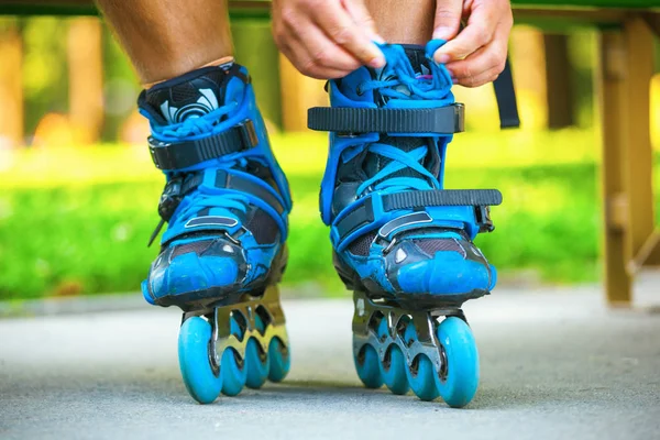 Closeup of roller tying laces on inline roller skates. — Stock Photo, Image