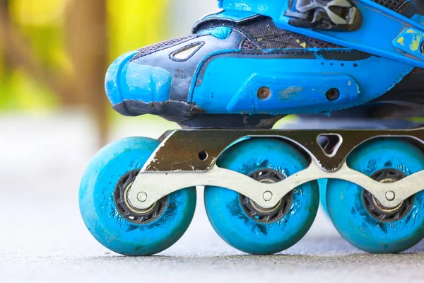 Closeup of inline roller skates with blue wheels. — Stock Photo, Image