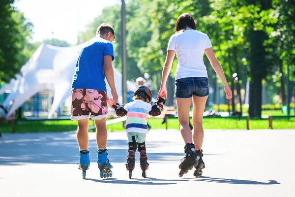 Bonito menino e sua mãe aprendendo patinação em linha — Fotografia de Stock