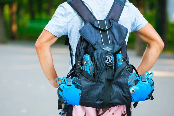 Young male roller skater with roller backpack - shoot from behin — Stock Photo, Image