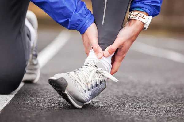 Cropped shot of a young man holding his ankle in pain sprain a f — Stock Photo, Image