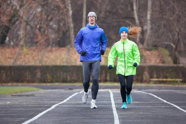 Shot of a young couple running outdoors. — Stock Photo, Image