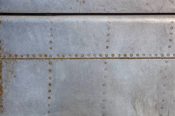 Close up of old aircraft aluminum texture with rivets.