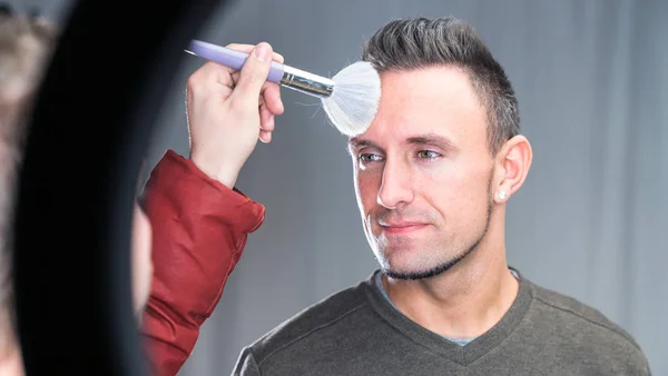 stock image makeup artist working on models face