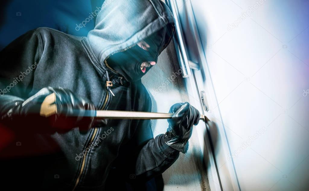 masked burglar with crowbar 