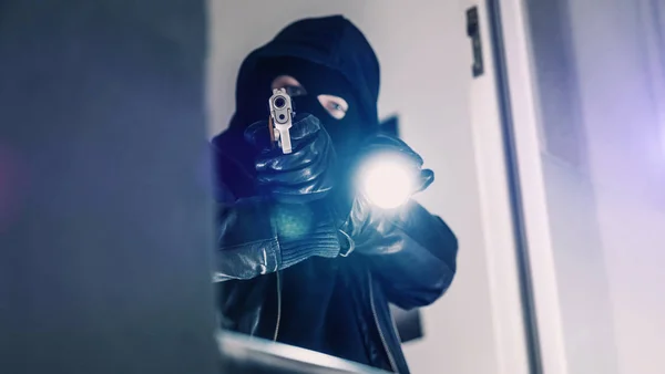 Грабитель в маске с пистолетом — стоковое фото
