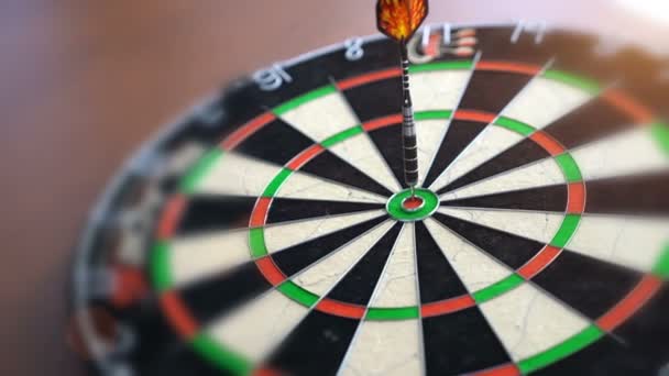 Darts hitting the bulls eye on a dartboard — Stock Video