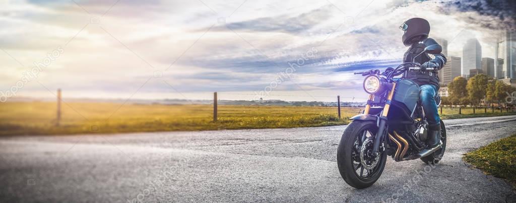 man on motorbike riding on the road