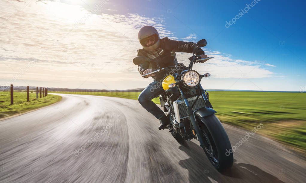 man on motorbike riding on the road