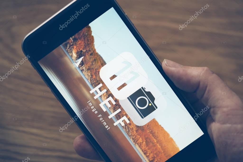 AACHEN, GERMANY - JUNE 22, 2017: HEIF Logo on  Apple iPone 7. HEIF is a new image compression used by apple in iOS 11 to reduce the storage on mobile devices, developed by the Moving Picture Experts Group (MPEG).