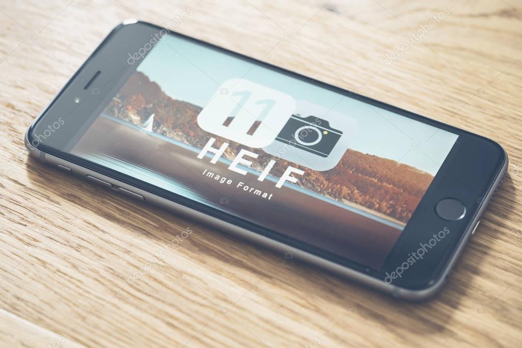 AACHEN, GERMANY - JUNE 22, 2017: HEIF Logo on  Apple iPone 7. HEIF is a new image compression used by apple in iOS 11 to reduce the storage on mobile devices, developed by the Moving Picture Experts Group (MPEG).