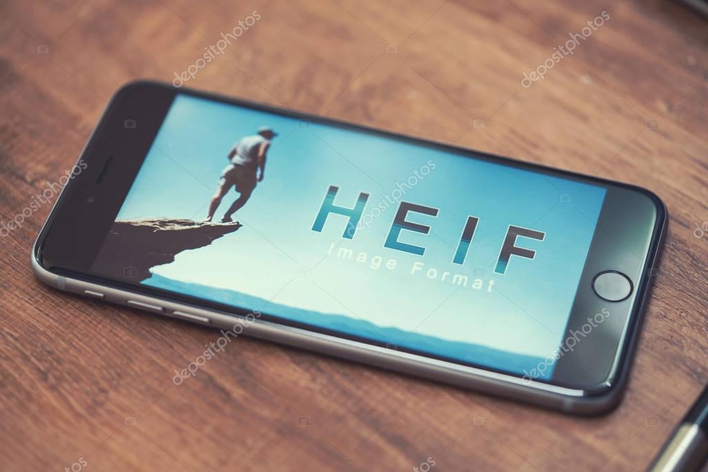 AACHEN, GERMANY - JUNE 22, 2017: HEIF Logo on  Apple iPone 7. HEIF is a new image compression used by apple in iOS 11 to reduce the storage on mobile devices, developed by the Moving Picture Experts Group (MPEG).
