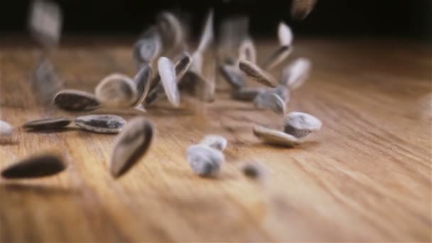 Some Sunflower Seeds Poured Out Wooden Table Sliding Camera Slow — Stock Video