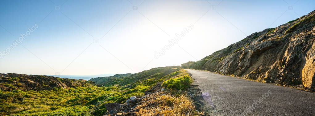 Empty long mountain road to the horizon on a sunny summer day at