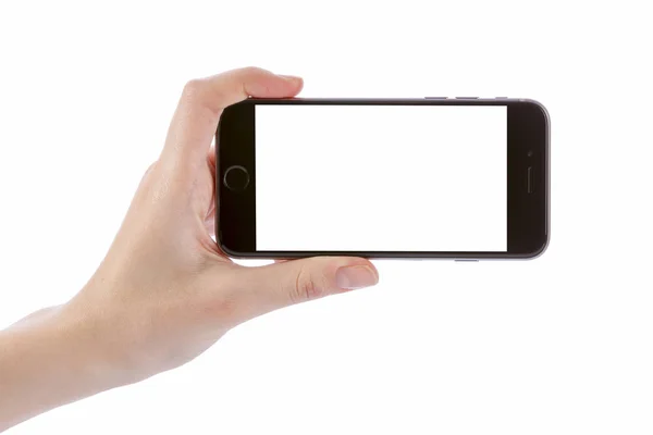 Mão segurando telefone inteligente preto isolado no branco — Fotografia de Stock