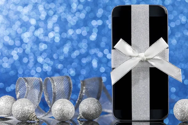 Smartphone Decorations Christmas Tree Black Glass Table Blue Background Focus — Stock Photo, Image