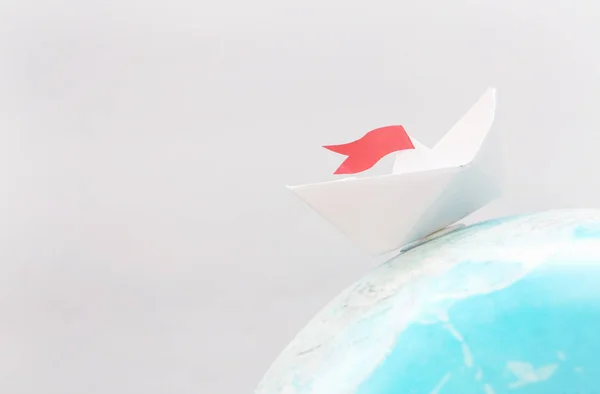 Travel concept with paper boat