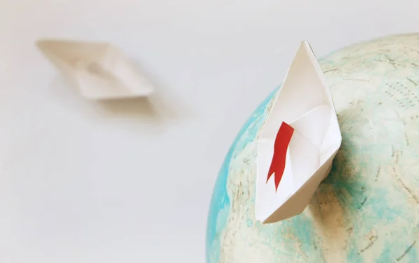 Travel concept with paper boat