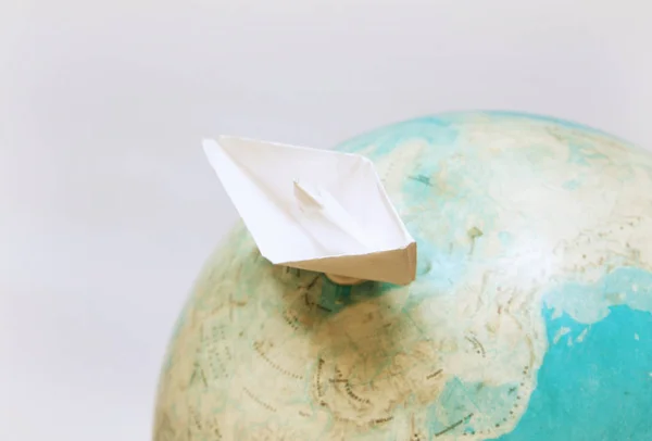 Travel concept with paper boat