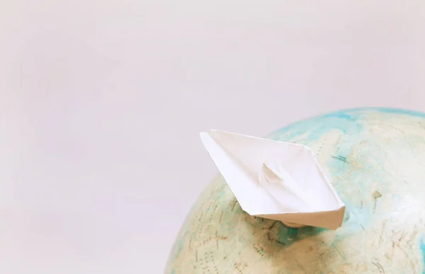 Travel concept with paper boat