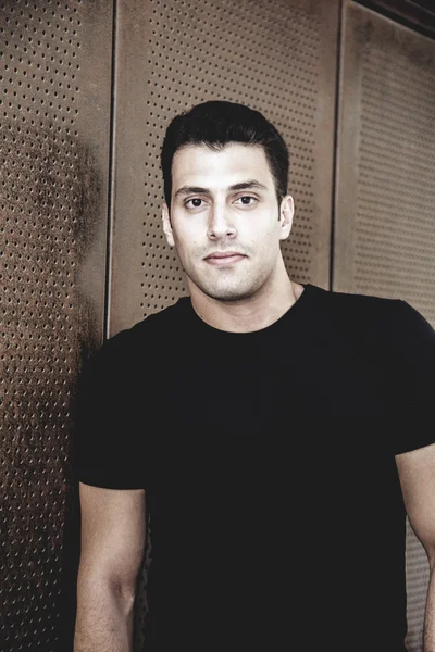 Young and attractive man in white shirt outdoor portrait