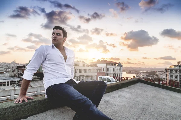 Young and attractive man in white shirt outdoor portrait