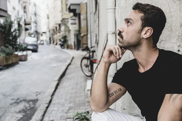 Young and attractive man in white shirt outdoor portrait