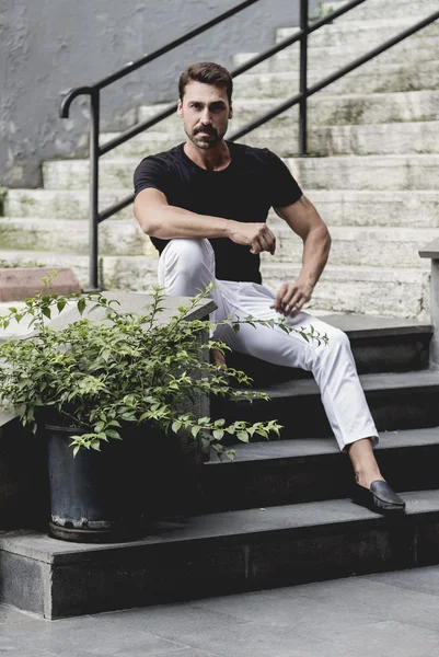 Young and attractive man in white shirt outdoor portrait