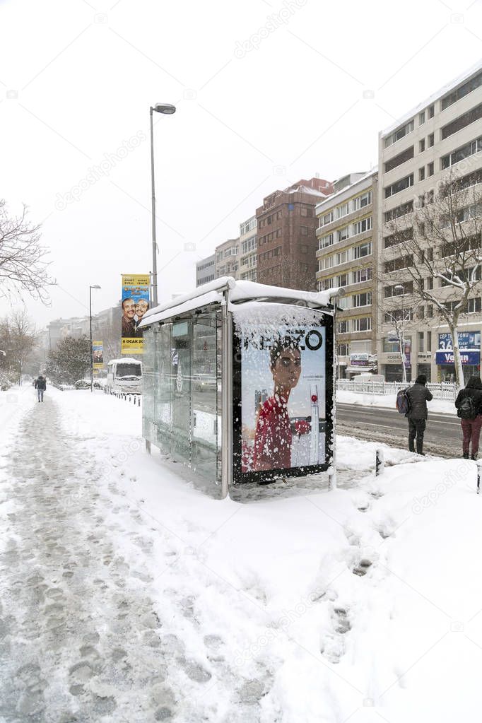 Istanbul, Turkey - January 8, 2017: Outdoor advertisement Kenzo fashion brand at a bus stop in Istanbul on a snowy day.