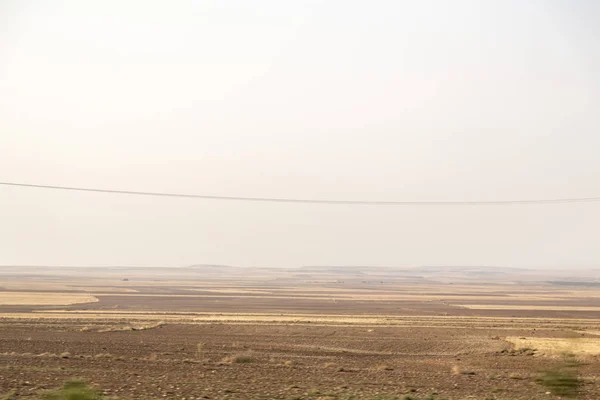 View of flat lands and small hills of the Central Anatolian geography from the road. Central Anatolia has arid climate with hot summers and extremely cold winters.