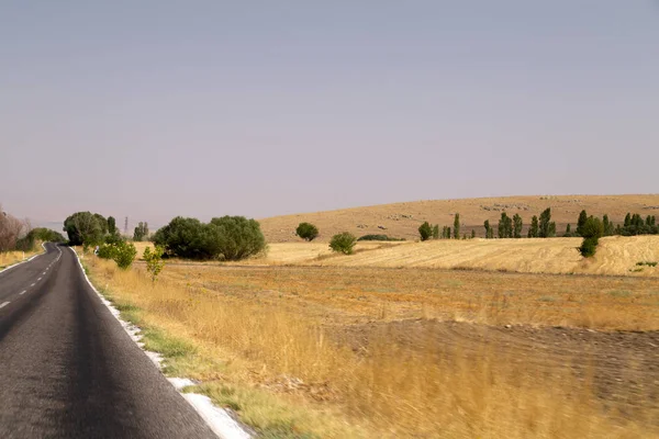 View of flat lands and small hills of the Central Anatolian geography from the road. Central Anatolia has arid climate with hot summers and extremely cold winters.