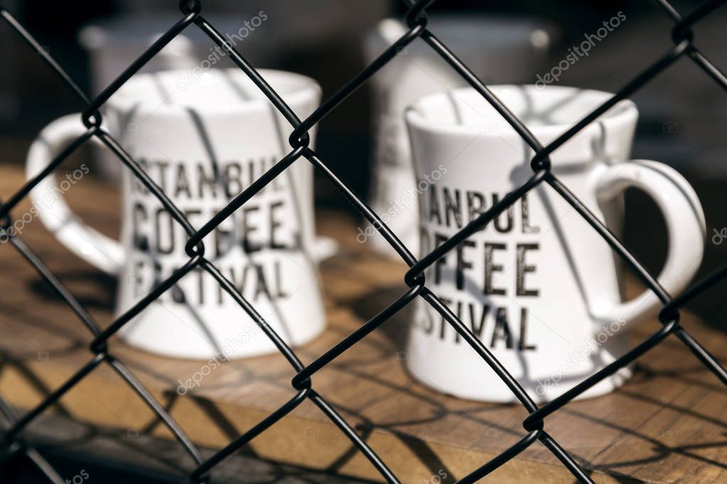 Istanbul, Turkey - September 24, 2017: Istanbul Coffee Festival held at Kucukciftlik Park in macka, Istanbul, Turkey. Official festival mugs on the wooden desk.