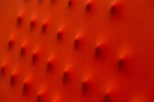 Utbuktningar på rött tyg närbild med textur — Stockfoto