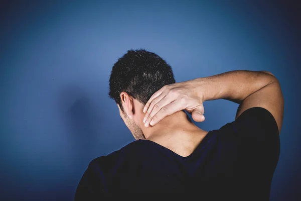 Young handsome man having neck problems — Stock Photo, Image