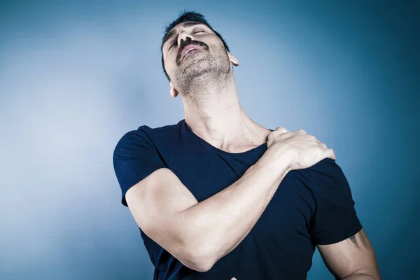 Young handsome man having shoulder problems — Stock Photo, Image