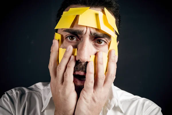 Young handsome man with sticky notes on his face — Stock Photo, Image