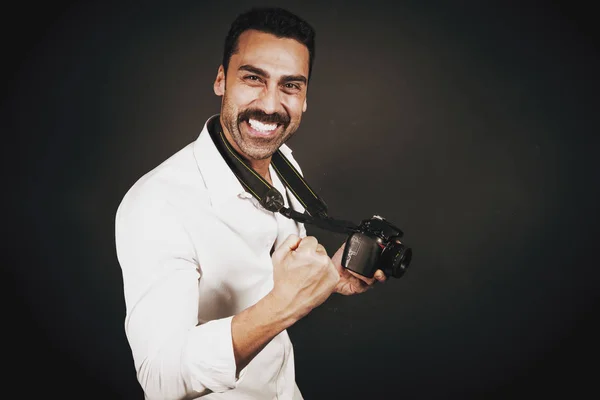 Young handsome photographer with beard and mustache studio portr