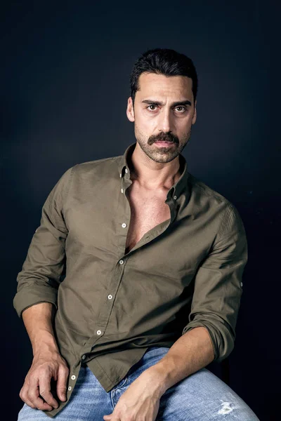 Young handsome man with beard and mustache studio portrait