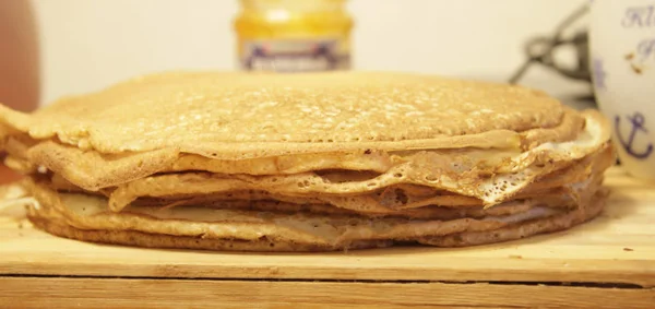 Stack of homemade pancakes on wood cooking board — Stock Photo, Image