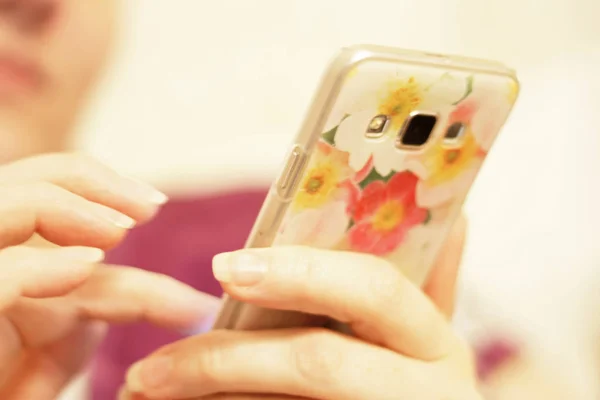 Рука жінки тримає смартфон і торкається екрана — стокове фото