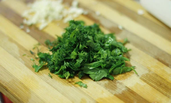 Cutting parsley and garlic on the wood desk — Stock Photo, Image