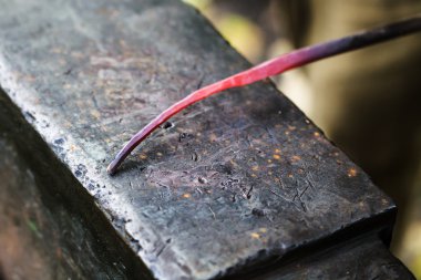 kırmızı sıcak parlak çelik çubuk örs üzerinde kapat