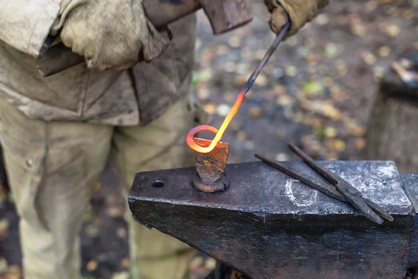 Blacksmith cut out a buckle with hammer and chisel — Stock Photo, Image