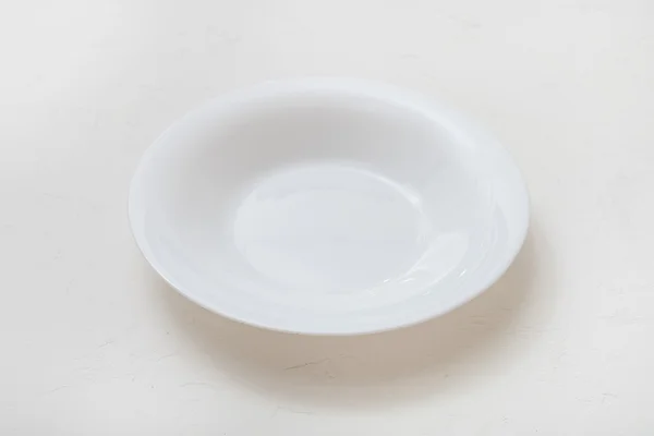 One white deep plate on plastering board — ストック写真