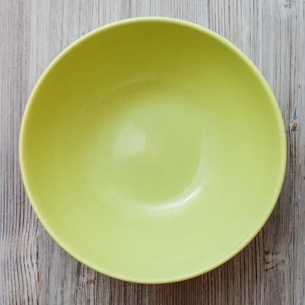Top view of green bowl on gray brown table — Stock Photo, Image