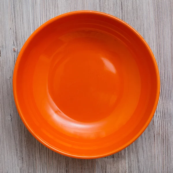 Top view of orange bowl on gray brown table — Stock Photo, Image