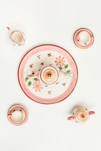 Top view of pink porcelain tea set on white paper — Stockfoto